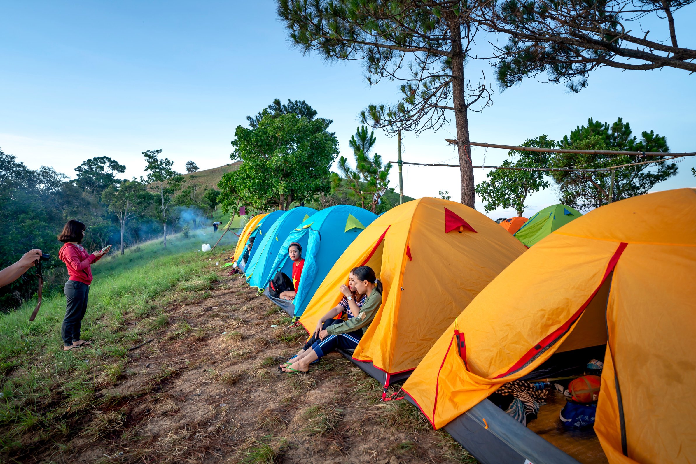 Anonymous people resting in camping tents